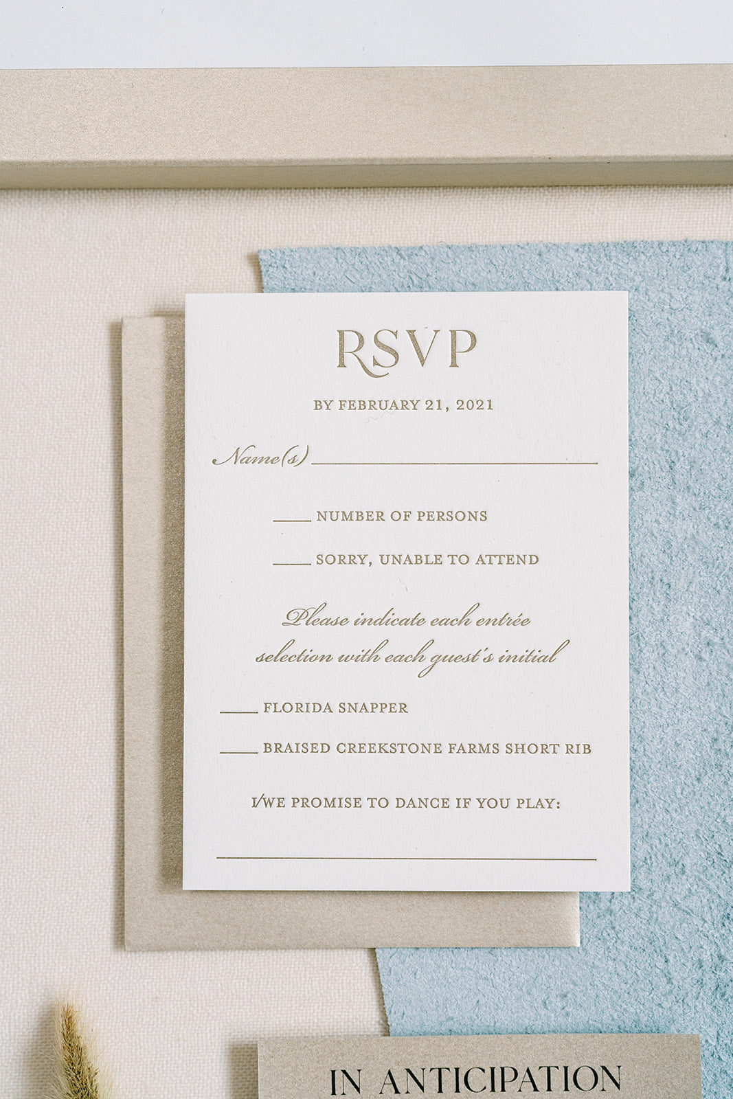 RSVP card with a beige envelope on a textured surface