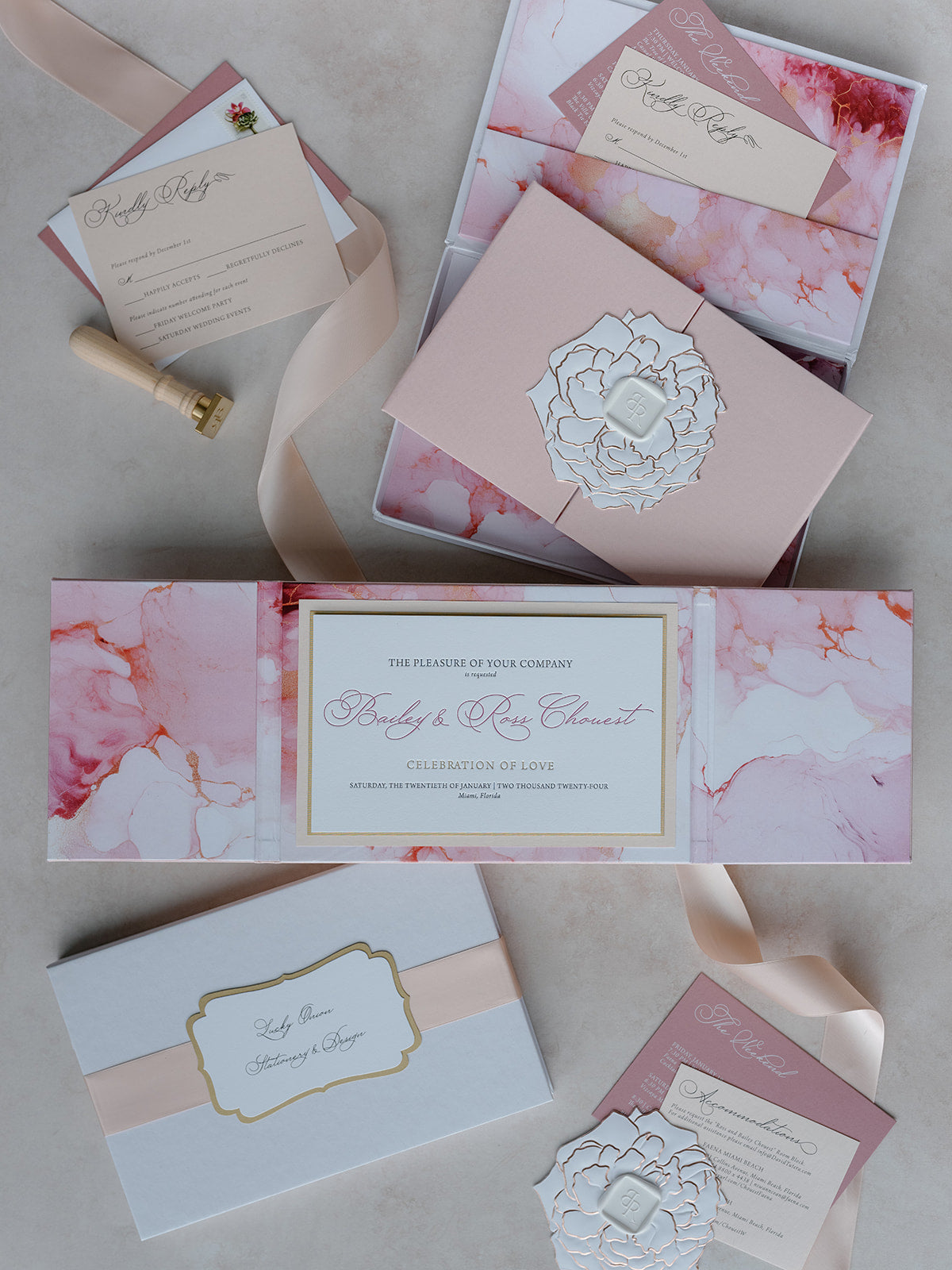Collection of elegant wedding invitations with floral designs on a neutral background
